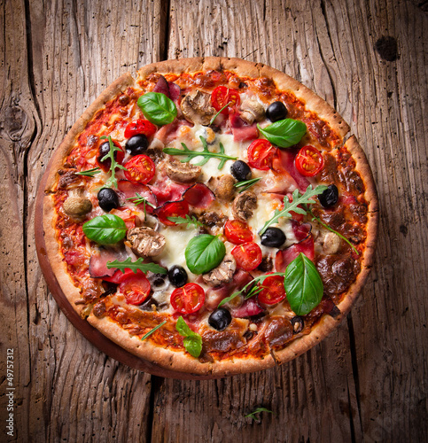 Fototapeta dla dzieci Delicious italian pizza served on wooden table
