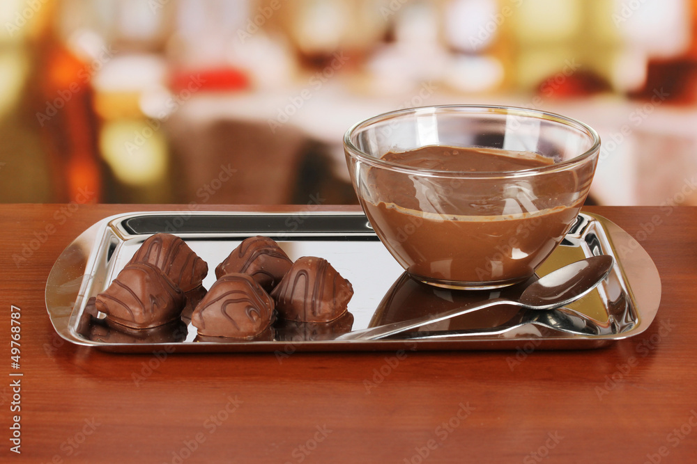 Bowl of chocolate and sweets on table in cafe
