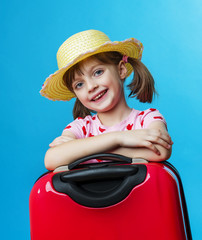 little girl with a red suitcase