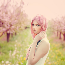 Beautiful Young Woman With Pink Hair In The Garden In Summer