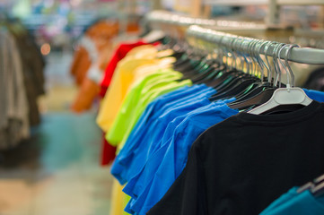 Bright color t-shirts on stands in kids store