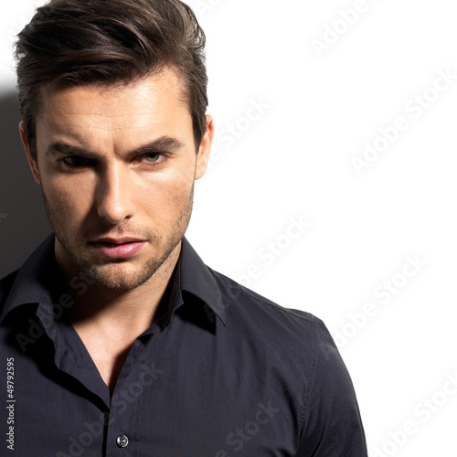 Fototapeta na wymiar Fashion portrait of young man in black shirt