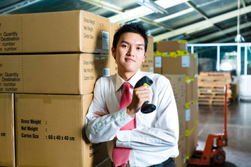 Young Man in a warehouse with Scanner