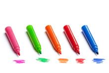 Row of colorful open markers with scribbles