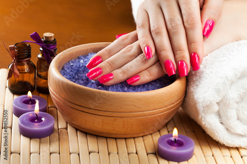 Nowoczesny obraz na płótnie female hands with aromatic candles and towel. Spa