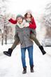 © pikselstock - Man giving woman piggyback in winter setting