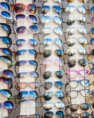 Wall Mural - Many sunglasses on display in shop