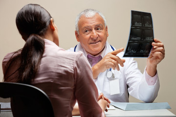 Wall Mural - Radiologist Showing X-ray To Patient