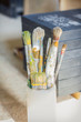 Set of paint brushes in front of canvas