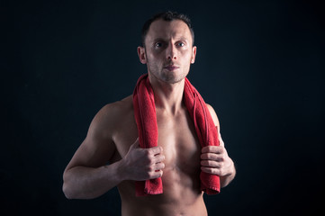 Wall Mural - Confident young man shirtless portrait with red towel