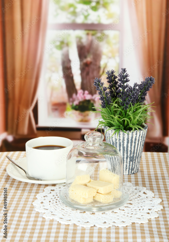 Chocolate pieces under glass cover and hot drink
