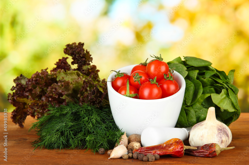Composition of mortar, spices, tomatoes and  green herbs,