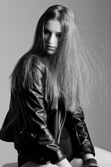 young model wearing a leather jacket posing fashion