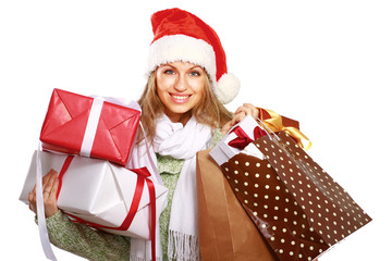 Wall Mural - Young woman with Santa hat holding shopping bags