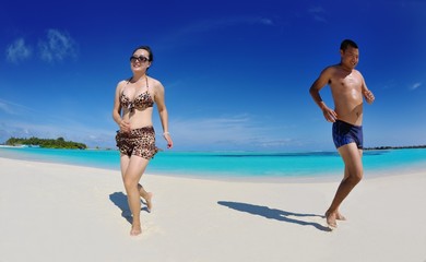 happy young  couple enjoying summer on beach