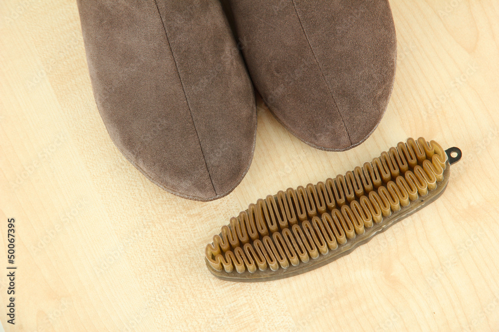 Brush for suede shoes, on wooden background