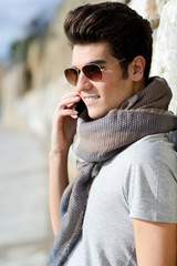 Handsome man in urban background talking on phone