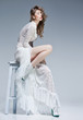 © matusciac - beautiful woman in long white dress posing fashion in the studio