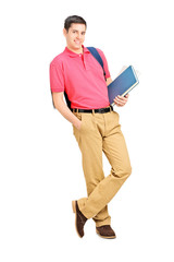 Poster - Full length portrait of a smiling student holding books and lean