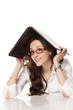 © vladimirfloyd - smiling girl covers her head with a laptop on white background