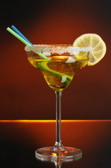 Poster - Yellow cocktail in glass on color background