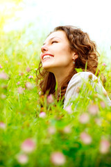 Wall Mural - beautiful young woman outdoors. enjoy nature. meadow