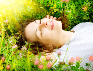 Wall Mural - beautiful young woman outdoors. enjoy nature. meadow