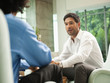 © Erik Isakson/Blend Images - Businessmen talking together in lobby