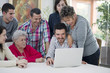 © GM Visuals/Blend Images - Hispanic family looking at laptop