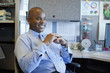 © Inti St Clair/Blend Images - African American businessman sitting in office cubicle