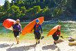 © Michael DeYoung/Blend Images - Caucasian family carrying kayaks