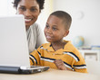 © JGI/Jamie Grill/Blend Images - Black mother and son using laptop together