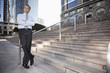 © Peathegee Inc/Blend Images - Hispanic businessman standing outdoors with arms crossed