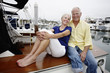 © Peathegee Inc/Blend Images - Couple relaxing on boat in marina