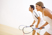 Hispanic Couple Playing Squash