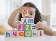 © JGI/Jamie Grill/Blend Images - Mixed race girl stacking blocks