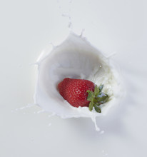 Strawberry Dropping Into Milk