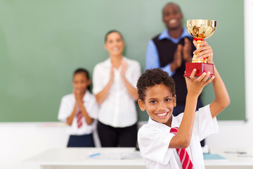 elementary school student holding a trophy