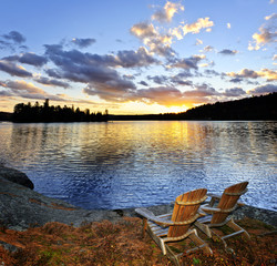 Wall Mural - Wooden chairs at sunset on beach