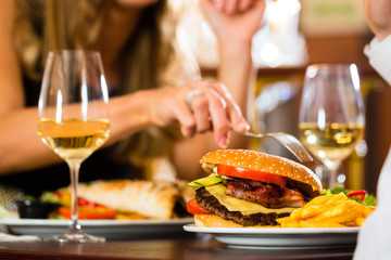 happy couple in restaurant eat fast food