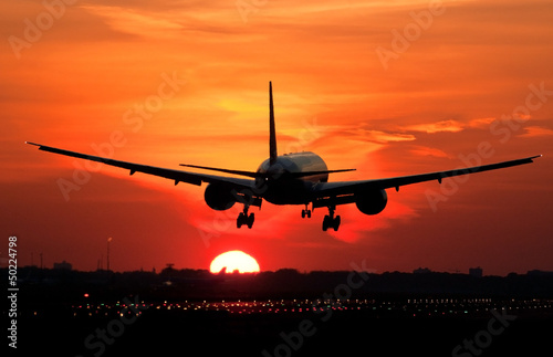 Fototapeta dla dzieci Plane landing in sunrise