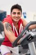 © pio3 - Young man training in the gym with bike.