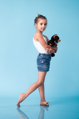 Wall Mural - cute little girl on blue background