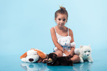 Wall Mural - cute little girl on blue background