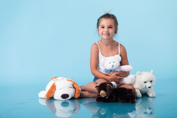 Wall Mural - cute little girl on blue background