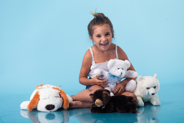 Wall Mural - cute little girl on blue background