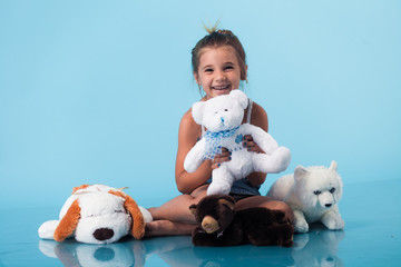 Wall Mural - cute little girl on blue background
