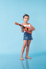 Wall Mural - cute little girl on blue background