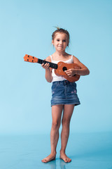 Wall Mural - cute little girl on blue background