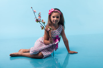 Wall Mural - cute little girl on blue background